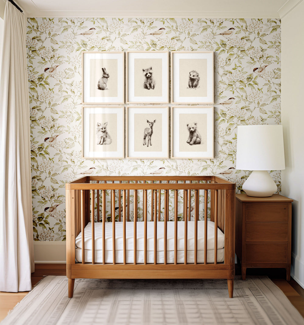 a baby's crib in front of a wall with pictures on it