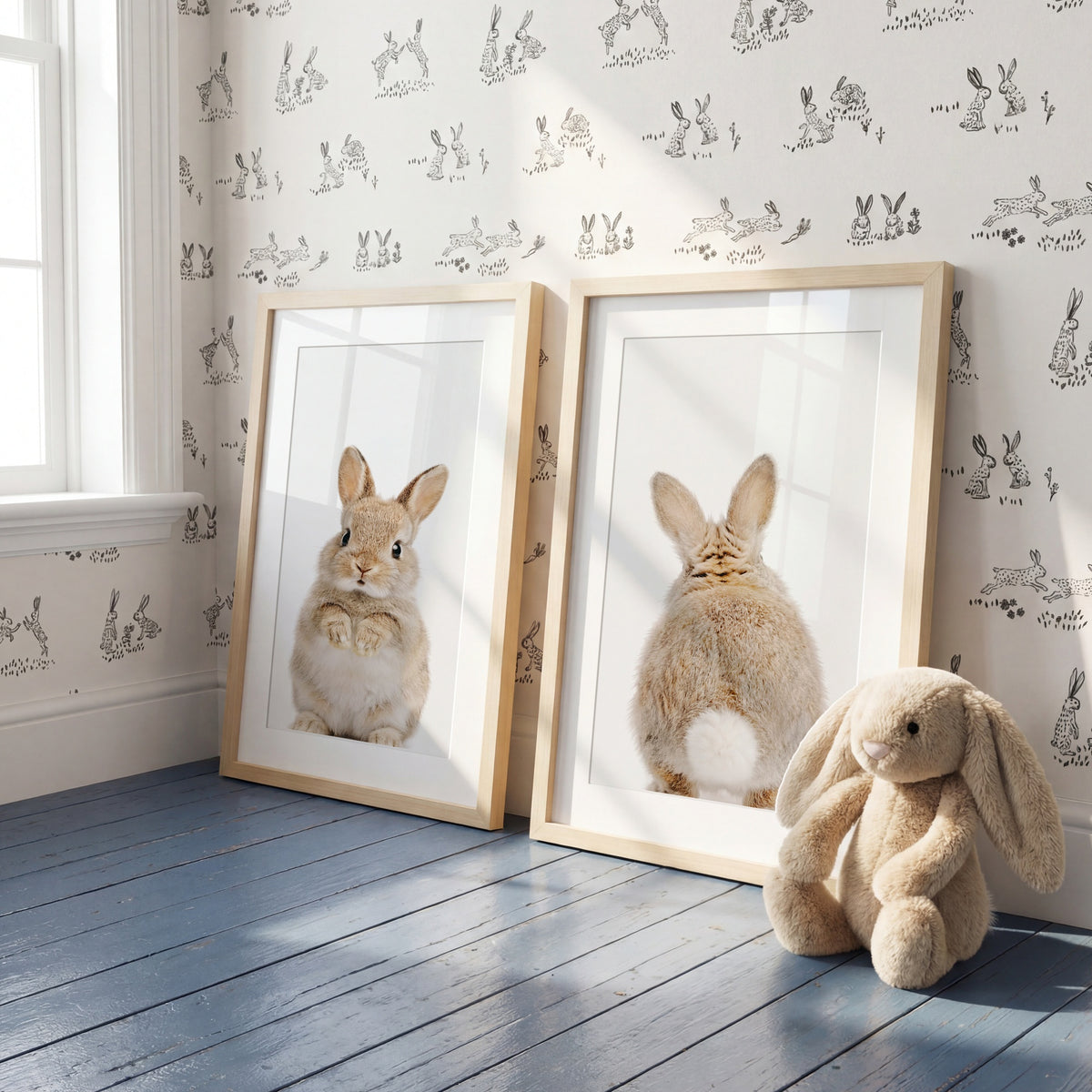 Two framed pictures of rabbits and a plush toy rabbit on a wooden floor with bunny-themed wallpaper. | The Crown Prints