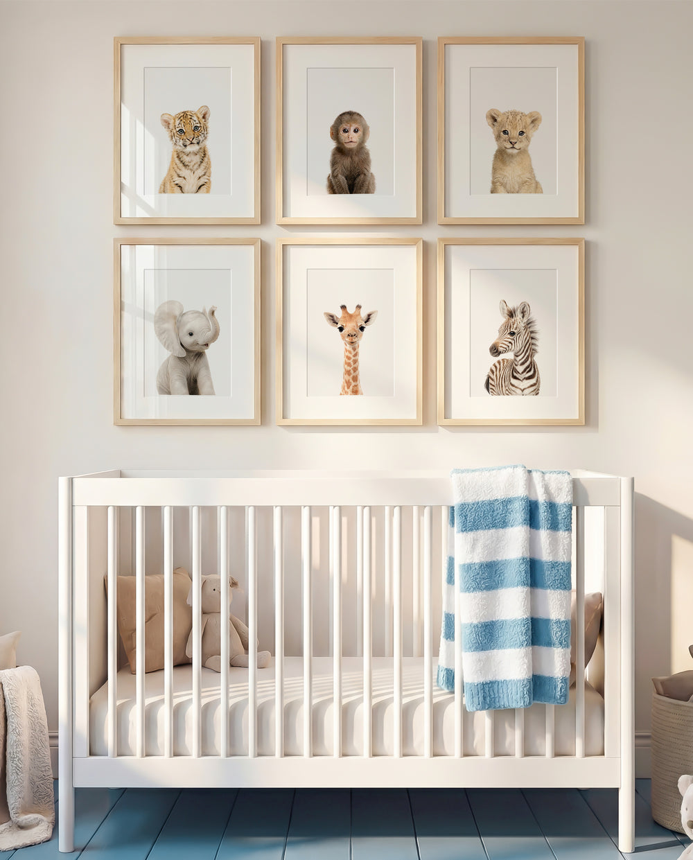 Nursery room with a white crib and framed animal prints on the wall. | The Crown Prints
