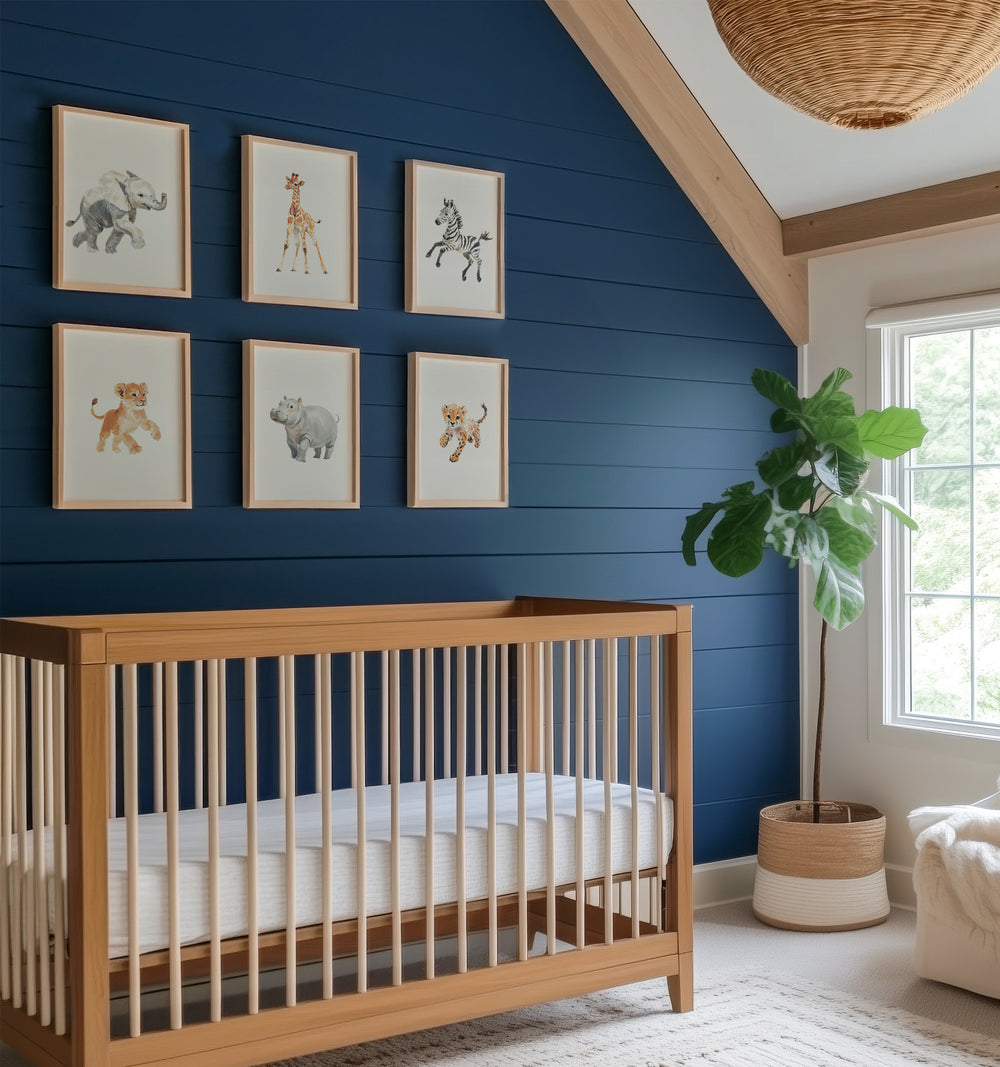 Nursery room with watercolor safari prints on the wall. The Crown Prints