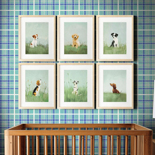 A series of framed nursery art picture prints featuring illustrated puppies arranged on a wall above a crib in a nursery room. The Crown Prints