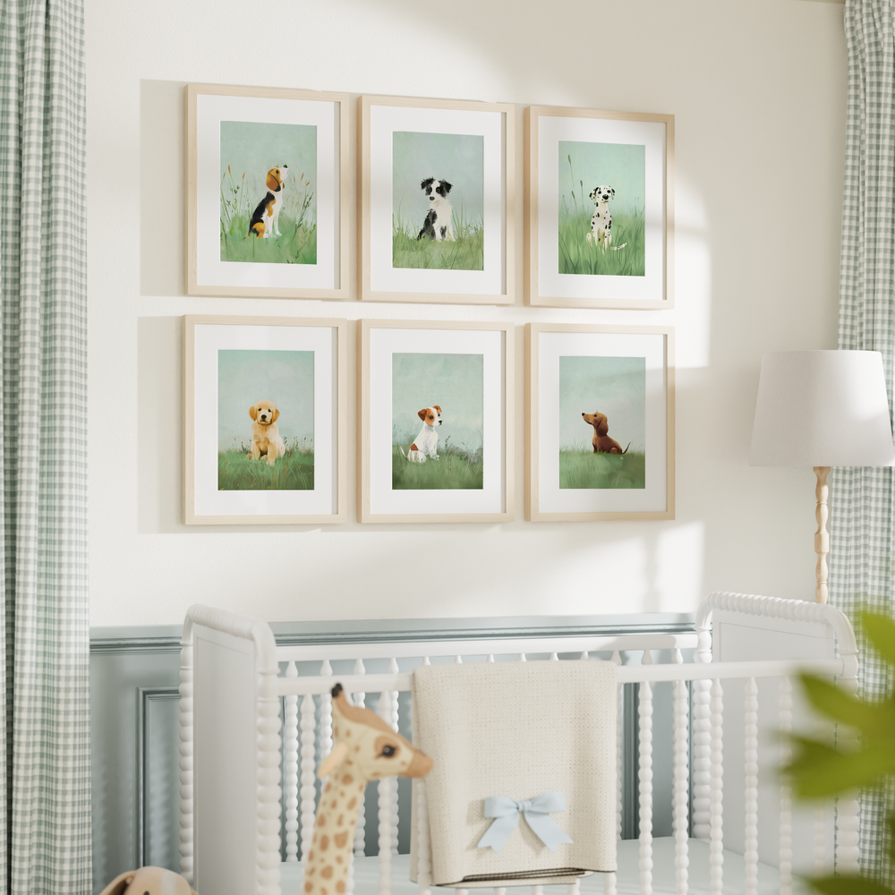 A series of framed nursery art picture prints featuring illustrated puppies arranged on a wall above a crib in a nursery room. The Crown Prints