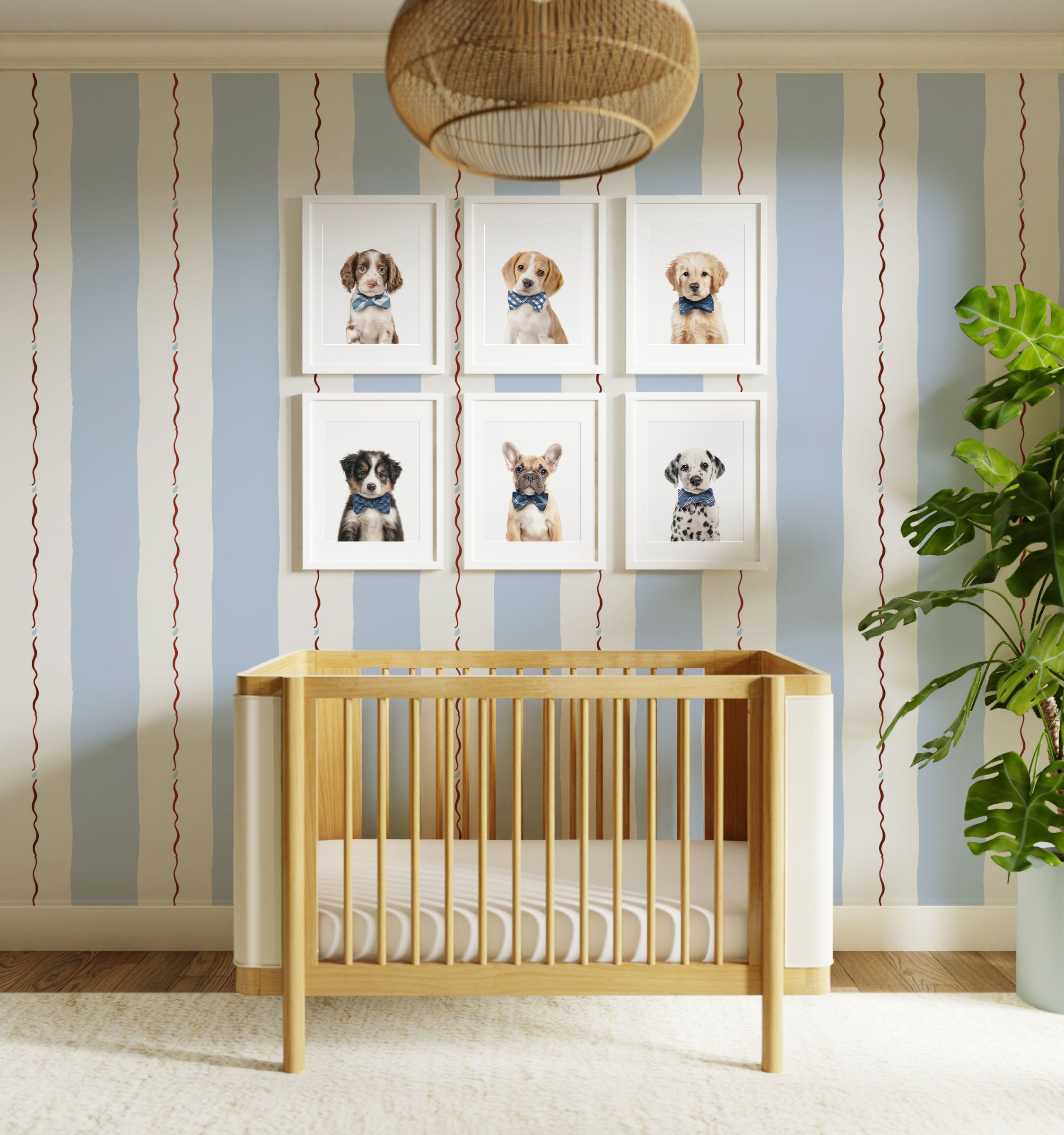 Nursery room with wooden crib, striped wall, and framed dog photos.