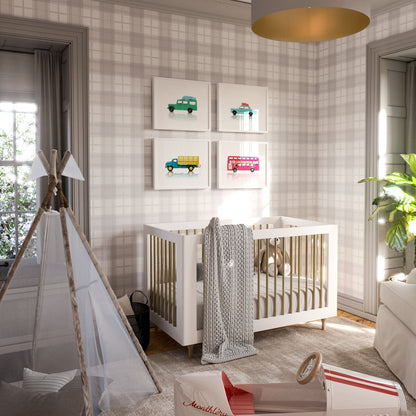 Boy's nursery room with framed toy car prints on the wall above crib